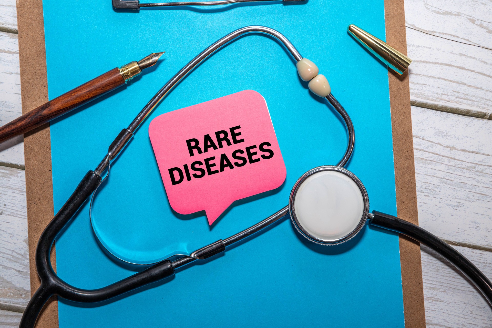 Stethoscope and white card with RARE DISEASES text on blue background.